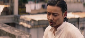 Movie still from “Master Z: The Ip Man Legacy” (2018), directed by Woo-Ping Yuen – A person wearing a white shirt; Close Up shot, Over the shoulder angle