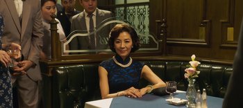 Movie still from “Master Z: The Ip Man Legacy” (2018), directed by Woo-Ping Yuen – A woman sitting at a table in front of a mirror; Medium shot, Over the shoulder angle