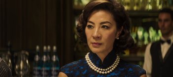 Movie still from “Master Z: The Ip Man Legacy” (2018), directed by Woo-Ping Yuen – An older woman wearing a blue dress and a pearl necklace; Close Up shot, Over the shoulder angle