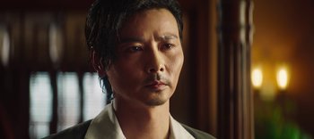 Movie still from “Master Z: The Ip Man Legacy” (2018), directed by Woo-Ping Yuen – A person wearing a white shirt; Close Up shot, Low angle
