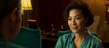 Movie still from “Master Z: The Ip Man Legacy” (2018), directed by Woo-Ping Yuen – A person sitting in a room; Close Up shot, Over the shoulder angle