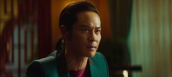 Movie still from “Master Z: The Ip Man Legacy” (2018), directed by Woo-Ping Yuen – A person wearing a green jacket; Close Up shot, Over the shoulder angle