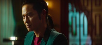 Movie still from “Master Z: The Ip Man Legacy” (2018), directed by Woo-Ping Yuen – A man in a green jacket looking to his left; Close Up shot, Over the shoulder angle