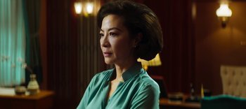 Movie still from “Master Z: The Ip Man Legacy” (2018), directed by Woo-Ping Yuen – A person wearing a green shirt; Close Up shot, Over the shoulder angle