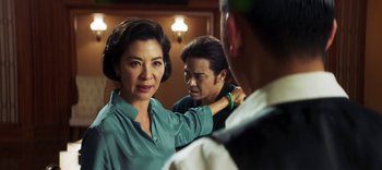 Movie still from “Master Z: The Ip Man Legacy” (2018), directed by Woo-Ping Yuen – A woman standing next to a man in a room; Close Up shot, Over the shoulder angle