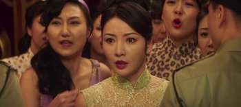 Movie still from “Master Z: The Ip Man Legacy” (2018), directed by Woo-Ping Yuen – A group of women standing next to each other in a room; Close Up shot, Over the shoulder angle