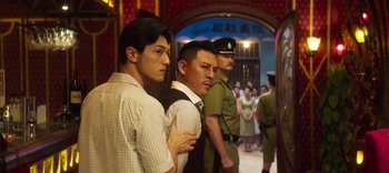 Movie still from “Master Z: The Ip Man Legacy” (2018), directed by Woo-Ping Yuen – A group of men standing next to each other in a room; Medium shot, Over the shoulder angle