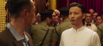 Movie still from “Master Z: The Ip Man Legacy” (2018), directed by Woo-Ping Yuen – A group of men standing next to each other in a room; Close Up shot, Over the shoulder angle