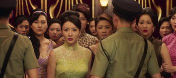 Movie still from “Master Z: The Ip Man Legacy” (2018), directed by Woo-Ping Yuen – A group of people standing next to each other in a room; Close Up shot, Over the shoulder angle