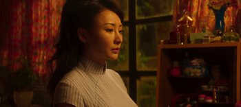 Movie still from “Master Z: The Ip Man Legacy” (2018), directed by Woo-Ping Yuen – A woman in a striped shirt looking to her left; Close Up shot, Low angle