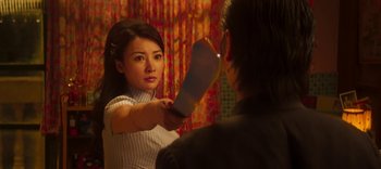Movie still from “Master Z: The Ip Man Legacy” (2018), directed by Woo-Ping Yuen – A woman holding a knife in front of a mirror; Close Up shot, Over the shoulder angle