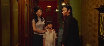 Movie still from “Master Z: The Ip Man Legacy” (2018), directed by Woo-Ping Yuen – A man and a woman standing next to a child; Medium shot, Over the shoulder angle
