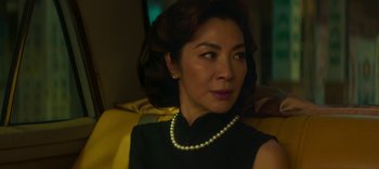 Movie still from “Master Z: The Ip Man Legacy” (2018), directed by Woo-Ping Yuen – A woman wearing a black dress and a pearl necklace; Close Up shot, Over the shoulder angle
