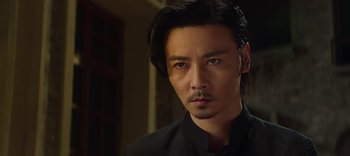 Movie still from “Master Z: The Ip Man Legacy” (2018), directed by Woo-Ping Yuen – A person wearing a black shirt; Close Up shot, Low angle