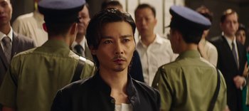Movie still from “Master Z: The Ip Man Legacy” (2018), directed by Woo-Ping Yuen – A group of men standing next to each other in a room; Close Up shot, Over the shoulder angle
