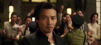 Movie still from “Master Z: The Ip Man Legacy” (2018), directed by Woo-Ping Yuen – A person wearing a black shirt; Close Up shot, Low angle