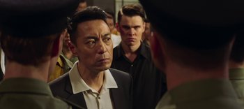 Movie still from “Master Z: The Ip Man Legacy” (2018), directed by Woo-Ping Yuen – A man in a black shirt and a man in a black shirt and a man in a black shirt and a man in a black shirt; Close Up shot, Over the shoulder angle