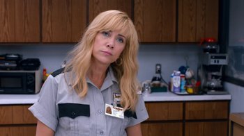 Movie still from “Masterminds” (2015), directed by Jared Hess – A woman with blonde hair wearing a police uniform; Close Up shot, Over the shoulder angle