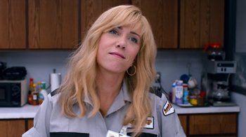 Movie still from “Masterminds” (2015), directed by Jared Hess – A woman with blonde hair wearing a uniform; Close Up shot, Over the shoulder angle