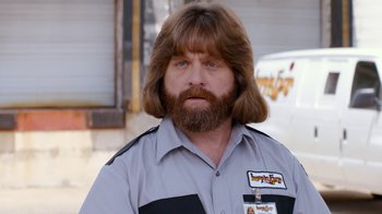 Movie still from “Masterminds” (2015), directed by Jared Hess – A person wearing a uniform; Close Up shot, Over the shoulder angle