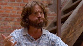 Movie still from “Masterminds” (2015), directed by Jared Hess – A man with long hair and a goatee is looking to his left; Close Up shot, Low angle