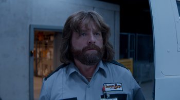 Movie still from “Masterminds” (2015), directed by Jared Hess – A person with long hair; Close Up shot, Low angle