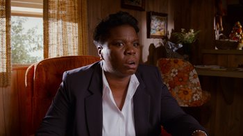 Movie still from “Masterminds” (2015), directed by Jared Hess – A woman sitting in a living room with her mouth wide open; Close Up shot, High angle