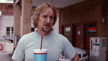 Movie still from “Masterminds” (2015), directed by Jared Hess – A person holding a cup with a straw; Close Up shot, Over the shoulder angle