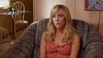 Movie still from “Masterminds” (2015), directed by Jared Hess – A woman sitting in a chair looking at the camera; Close Up shot, High angle
