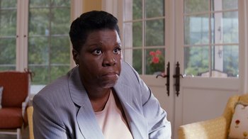 Movie still from “Masterminds” (2015), directed by Jared Hess – A woman sitting in front of a window looking sad; Close Up shot, Over the shoulder angle