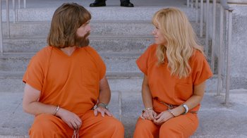 Movie still from “Masterminds” (2015), directed by Jared Hess – A couple of people that are sitting on some steps; Wide shot, High angle