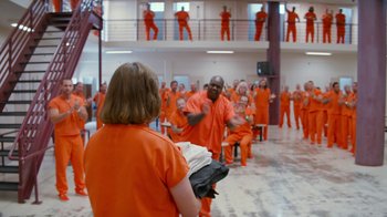 Movie still from “Masterminds” (2015), directed by Jared Hess – A group of men and women in orange jumpsuits; Wide shot, Over the shoulder angle