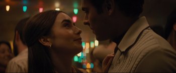 Movie still from “Extremely Wicked, Shockingly Evil and Vile” (2019), directed by Joe Berlinger – A man and a woman standing next to each other in front of lights; Close Up shot, Low angle