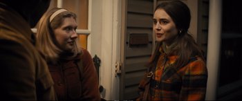 Movie still from “Extremely Wicked, Shockingly Evil and Vile” (2019), directed by Joe Berlinger – Two women standing next to each other in front of a building; Medium shot, Over the shoulder angle