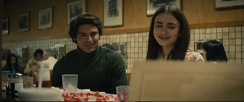 Movie still from “Extremely Wicked, Shockingly Evil and Vile” (2019), directed by Joe Berlinger – A man and a woman sitting at a dinner table; Medium shot, Over the shoulder angle