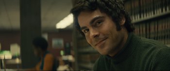 Movie still from “Extremely Wicked, Shockingly Evil and Vile” (2019), directed by Joe Berlinger – A person smiling for the camera; Close Up shot, Over the shoulder angle