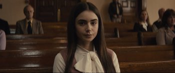 Movie still from “Extremely Wicked, Shockingly Evil and Vile” (2019), directed by Joe Berlinger – A woman with long brown hair sitting in a chair; Close Up shot, Over the shoulder angle