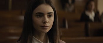 Movie still from “Extremely Wicked, Shockingly Evil and Vile” (2019), directed by Joe Berlinger – A person with long brown hair; Close Up shot, Over the shoulder angle