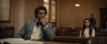Movie still from “Extremely Wicked, Shockingly Evil and Vile” (2019), directed by Joe Berlinger – A man sitting in front of a judge in a courtroom; Medium shot, Over the shoulder angle