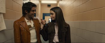 Movie still from “Extremely Wicked, Shockingly Evil and Vile” (2019), directed by Joe Berlinger – A man and a woman holding hands in a hallway; Medium shot, Over the shoulder angle