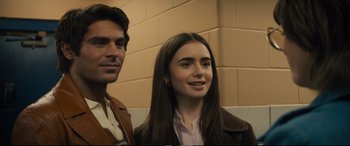 Movie still from “Extremely Wicked, Shockingly Evil and Vile” (2019), directed by Joe Berlinger – A man standing next to a woman in front of a brick wall; Close Up shot, Over the shoulder angle