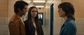 Movie still from “Extremely Wicked, Shockingly Evil and Vile” (2019), directed by Joe Berlinger – A group of people standing in a hallway talking to each other; Medium shot, Over the shoulder angle