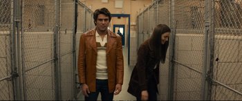 Movie still from “Extremely Wicked, Shockingly Evil and Vile” (2019), directed by Joe Berlinger – A man and a woman walking in a hallway; Medium shot, Low angle