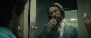 Movie still from “Extremely Wicked, Shockingly Evil and Vile” (2019), directed by Joe Berlinger – A man in a suit talking on a phone; Close Up shot, Over the shoulder angle