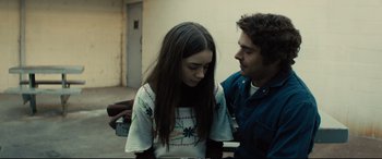 Movie still from “Extremely Wicked, Shockingly Evil and Vile” (2019), directed by Joe Berlinger – A man and a woman standing next to each other; Medium shot, Over the shoulder angle