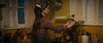 Movie still from “Extremely Wicked, Shockingly Evil and Vile” (2019), directed by Joe Berlinger – A woman in a kitchen cutting vegetables on a cutting board; Medium shot, Over the shoulder angle