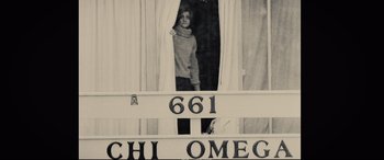Movie still from “Extremely Wicked, Shockingly Evil and Vile” (2019), directed by Joe Berlinger – A young girl looking out of a window; Medium shot, Low angle