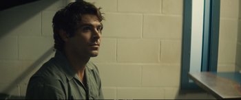 Movie still from “Extremely Wicked, Shockingly Evil and Vile” (2019), directed by Joe Berlinger – A person wearing a green shirt near a white wall; Close Up shot, Over the shoulder angle
