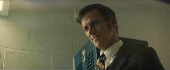 Movie still from “Extremely Wicked, Shockingly Evil and Vile” (2019), directed by Joe Berlinger – A person wearing a suit and tie; Close Up shot, Over the shoulder angle