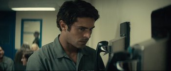 Movie still from “Extremely Wicked, Shockingly Evil and Vile” (2019), directed by Joe Berlinger – A person looking at a camera; Close Up shot, Low angle